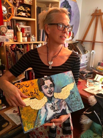 Juliana Coles holding journal featuring painting of her mom
