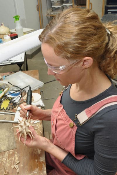 Kristin LeVier carving in shop