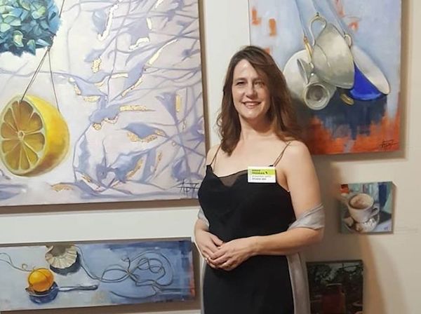 Artist Andie Freeman displays her paintings at a recent gala