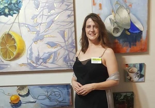 Artist Andie Freeman displays her paintings at a recent gala