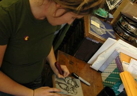 Bethany Taylor carving image of herself and her son into linoleum block-brighter